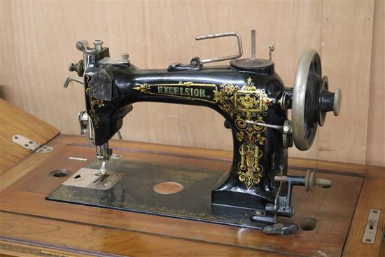 An Excelsior sewing machine within table W.95cm